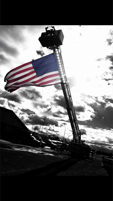 Fire Truck With Crane Up and American Flag Flying