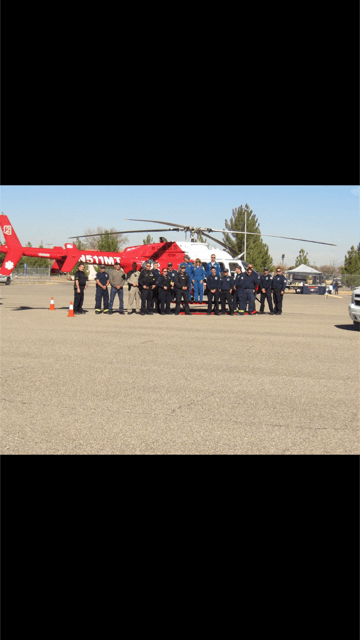 Group of Firefighters Standing Next to a Helicopter